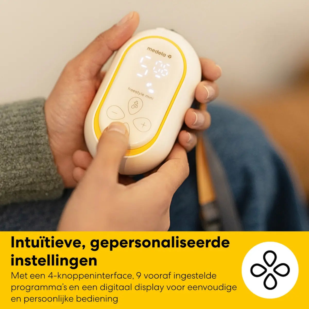 Hand houdt de compacte en eenvoudig te bedienen Medela Freestyle Mini kolfmotor vast.